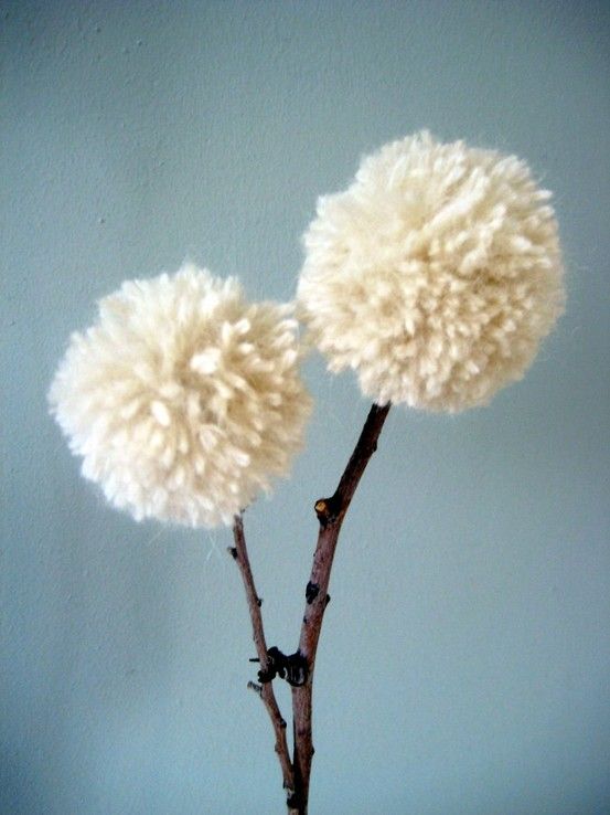 two fluffy balls on a twig in front of a light blue wall with the words, i can't get enough of these fuzzy stuff to make me smile