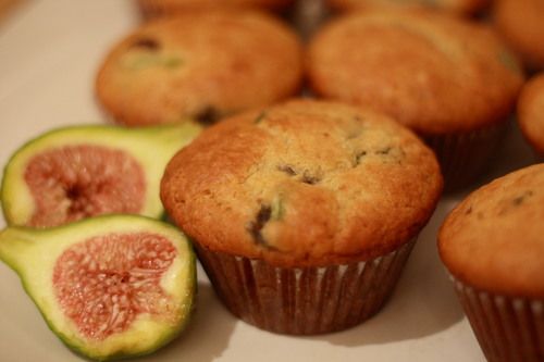 some muffins with figurines and one cut in half on a plate