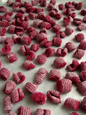 some red food is laying out on a table and ready to be cooked in the oven