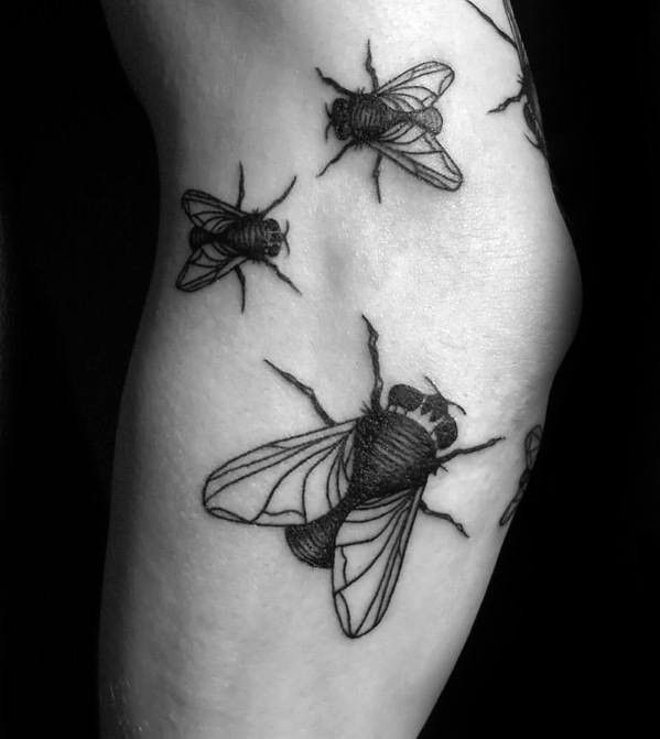 black and white photo of three bees on the arm