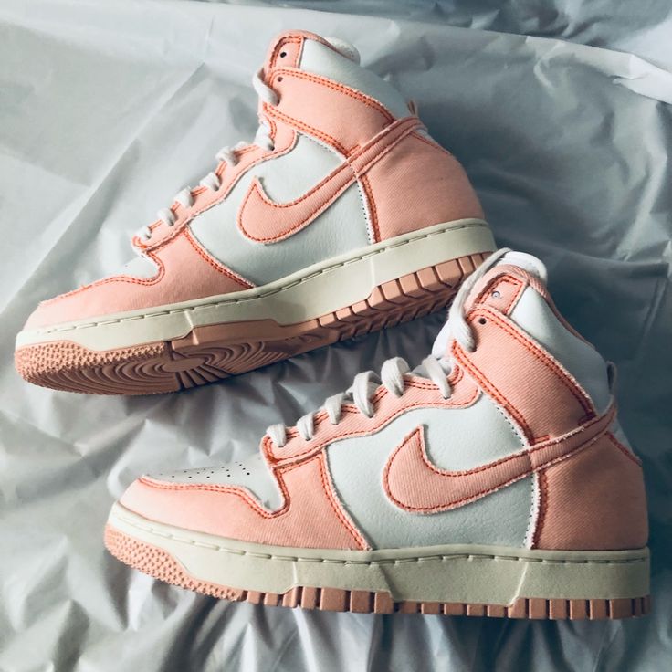 The Nike Dunk High “1985” Arctic Orange W Was Included In The Women's Catalog. It Arrived In An Artic Orange, Summit White, And Sail Colorway. The Shoes Upper Is Made Of A Pure White Leather Base And Canvas Overlays Across The Heel, Around The Toe And Along The Tongue. It Also Features A Tall Cushioned Collar And A Tiny Pull Tab Attached To Its Rear. Branding Details Include A Nike Branding Tag On The Tongue And Nike Swooshes On Both Sides. The Sneaker Rides On A White Accented Rubber Midsole At Nike Retro High-top Sneakers With Cushioned Footbed, Retro Nike High-top Sneakers With Cushioned Footbed, Retro White Basketball Shoes With Contrast Sole, Retro Basketball Shoes With Contrast Sole, Vintage Basketball Shoes With Boost Midsole And Round Toe, Retro Nike High-top Sneakers For Spring, Retro High-top Custom Sneakers, Retro White High-top Sneakers With Cushioned Footbed, Custom Retro Sneakers For Streetwear