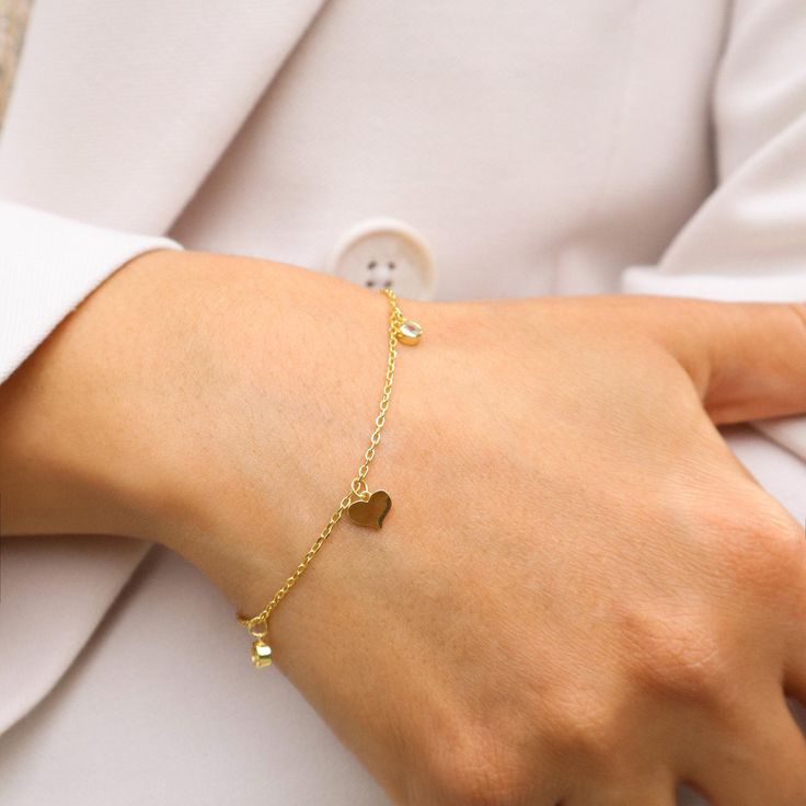 14K Gold-Plated Silver Bracelet with Elegant Heart Charms - A Timeless Expression of Love. 💖 Celebrate Love with Every Wrist Flick 💖 Introducing our exquisite 14K gold-plated silver bracelet, adorned with delicate heart charms. This bracelet isn't just an accessory; it's a symbol of love, affection, and the timeless bonds we share. Why You'll Adore This Bracelet: Elegant Heart Charms: Each heart charm is a reminder of love's enduring presence in our lives. Luxurious Craftsmanship: Crafted from Minimalist Metal Heart Bracelet As Gift, Minimalist Metal Heart Bracelet Gift, Name Bracelet With Heart Charm For Gift, Elegant Dangle Charm Bracelet For Valentine's Day, Minimalist Metal Charm Bracelet For Valentine's Day, Tarnish Resistant Charm Bracelet For Anniversary, Valentine's Day Minimalist Metal Charm Bracelet, Adjustable Silver Heart Bracelet Gold Plated, Gold Plated Dangle Charm Bracelet Gift