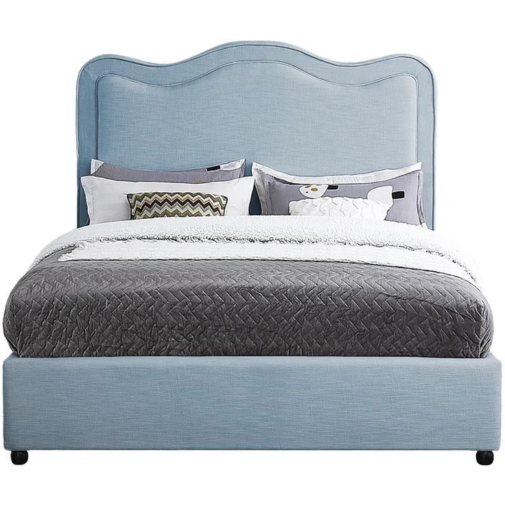 a bed with blue headboard and pillows on it's sides, in front of a white background