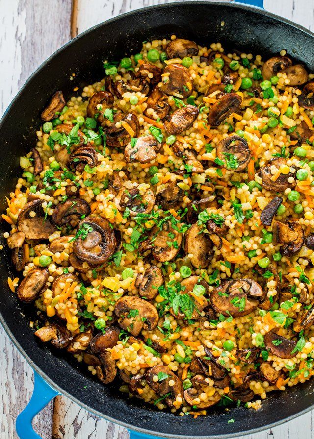 a skillet filled with rice and mushrooms