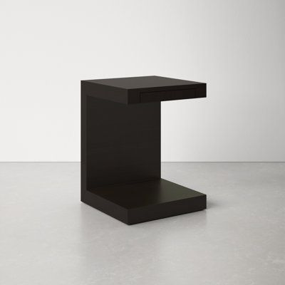 a black square table sitting on top of a white floor in front of a wall