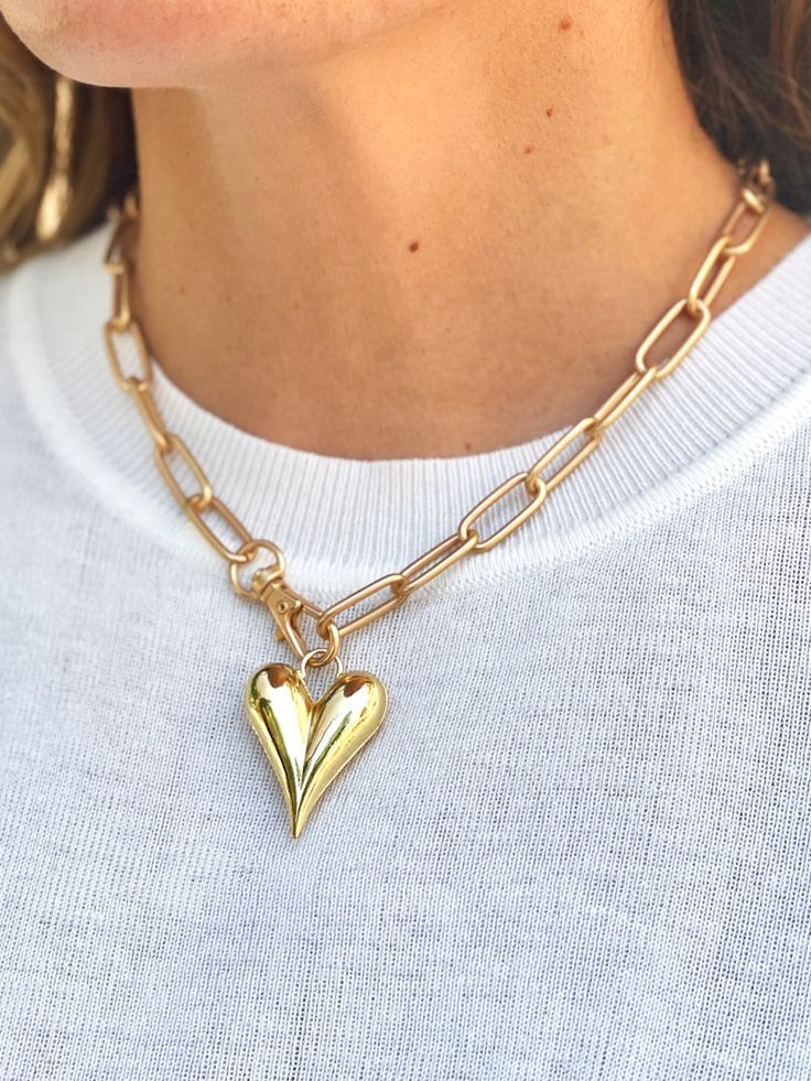 a golden plump heart pendant necklace with a large gold chain link Fall Linen, Fall Candle Scents, Paperclip Chain Necklace, Gold Heart Necklace, Sentimental Gifts, Gold Heart, Winter 2024, Heart Of Gold, Heart Necklace