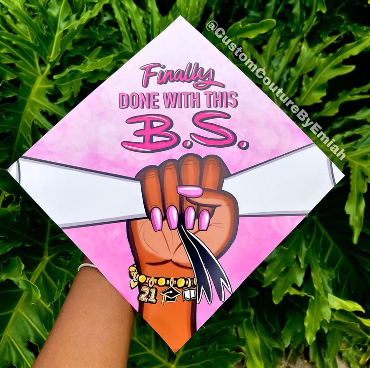 someone holding up a pink and white graduation cap that says, finally done with this bss