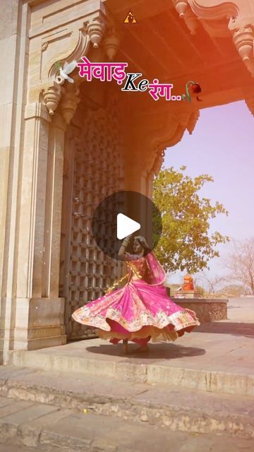 a woman in a pink dress is dancing on the steps outside an old building with columns and arches