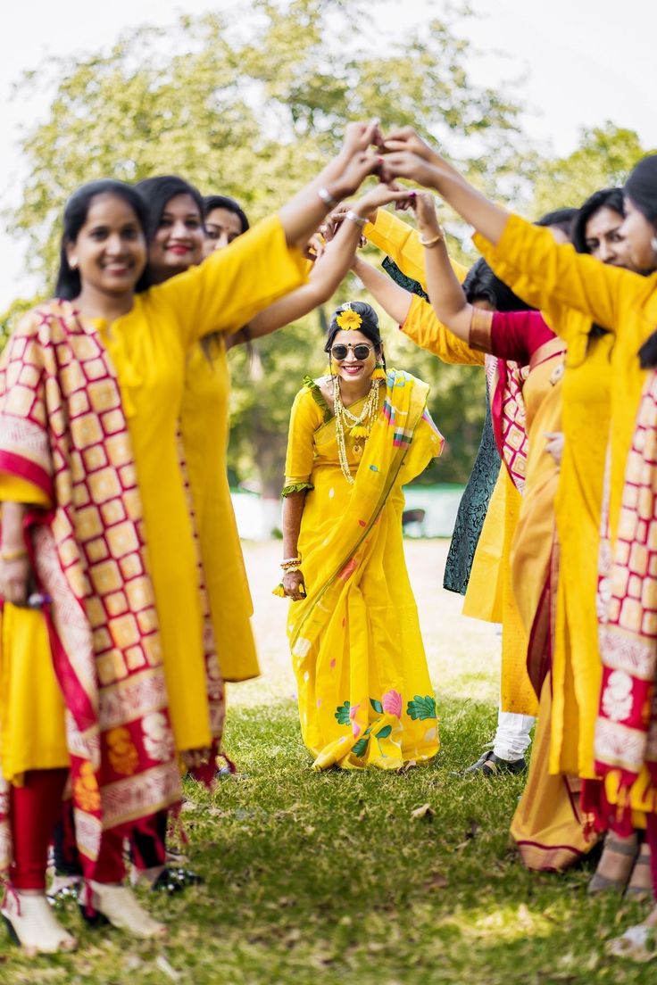 a group of women standing next to each other holding hands