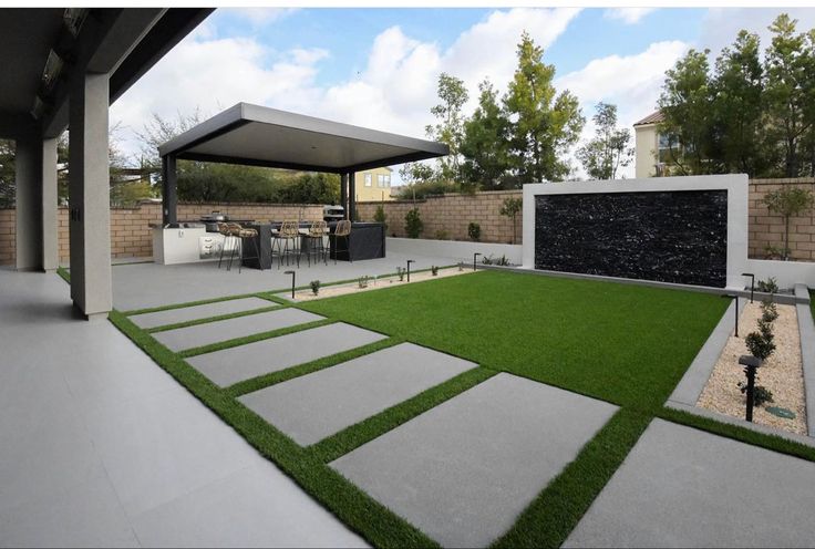 an outdoor living area with grass and landscaping