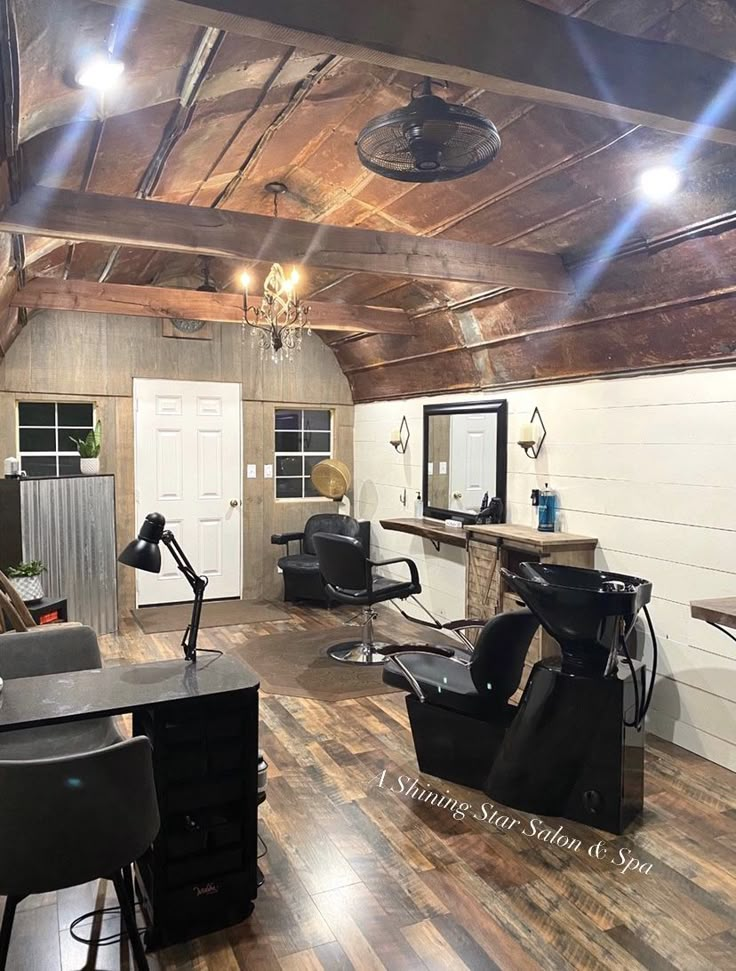 a room that has some chairs and lights in it with wood flooring on the walls