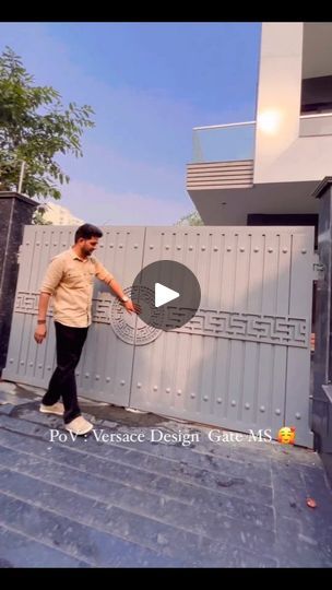 a man is walking up the stairs in front of a building with a video screen showing him