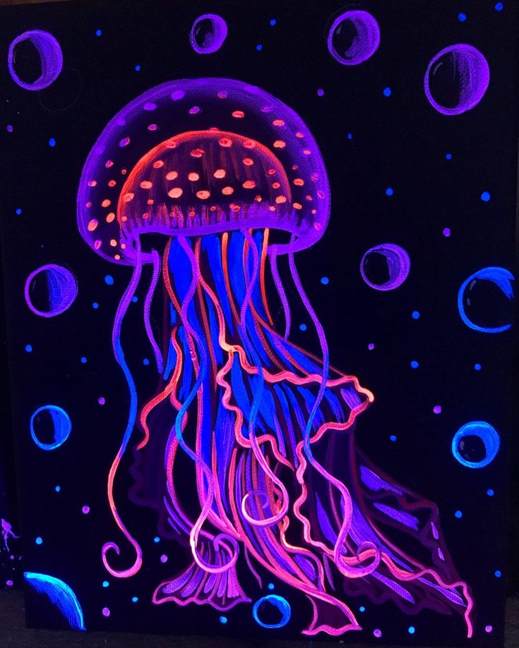 a jellyfish glows in the dark with blue and pink lights on it's body