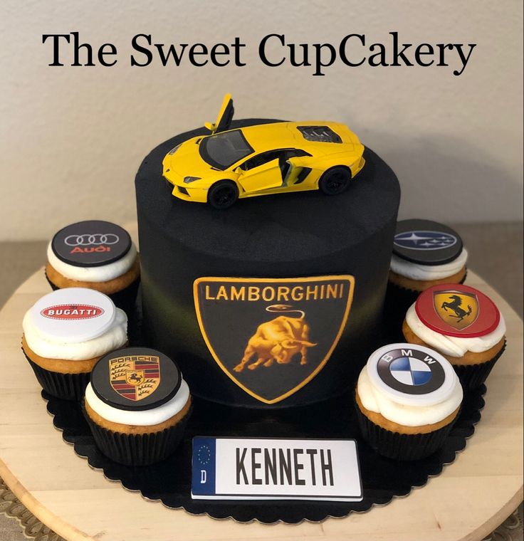 cupcakes are arranged in the shape of a race car on top of a cake