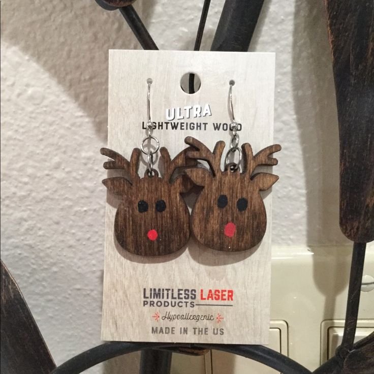 wooden reindeer earrings with red nose and antlers on them