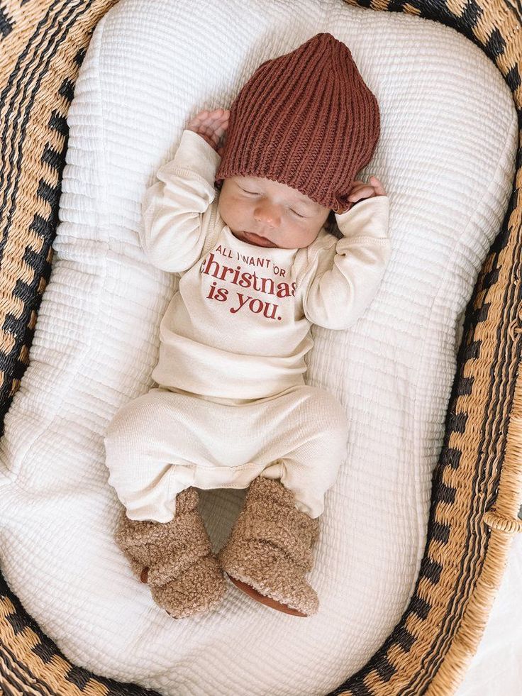 a baby is laying down in a basket