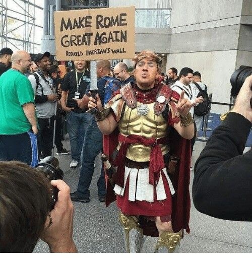 a man dressed in roman armor and holding a sign that says make rome great again