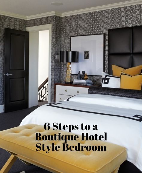 a bedroom with black and white wallpaper and yellow accents