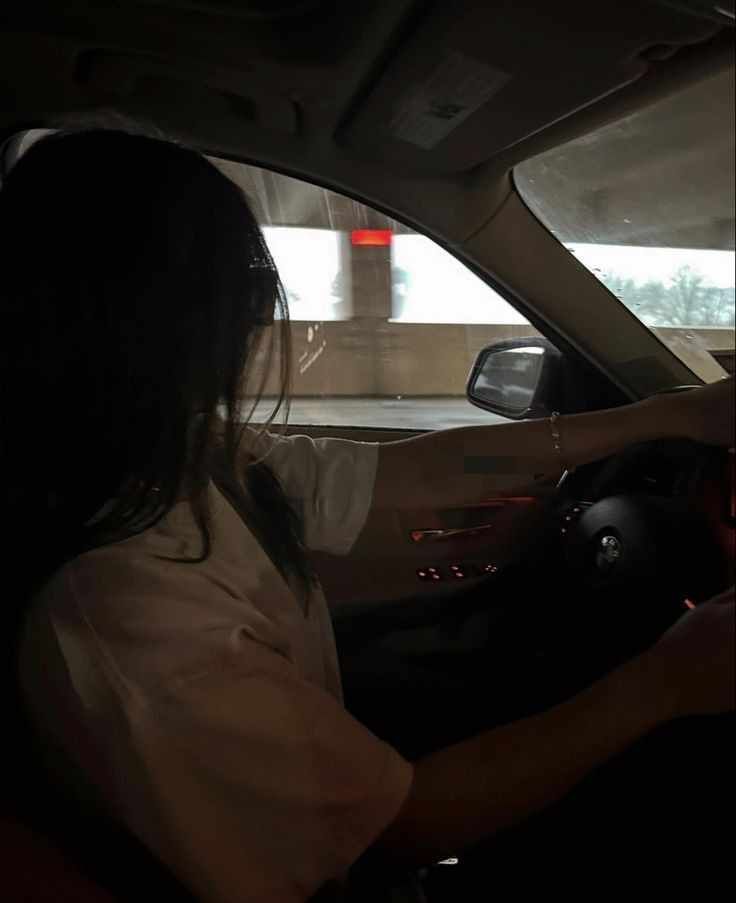 a woman sitting in the passenger seat of a car