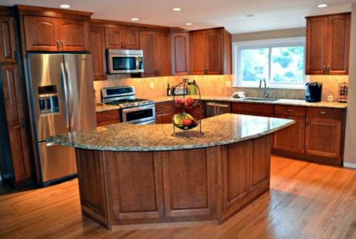 a large kitchen with wooden floors and stainless steel appliances