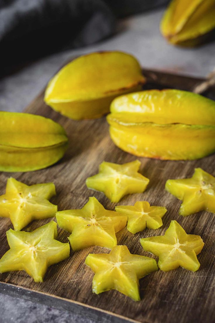 star fruit cut up on a wooden cutting board