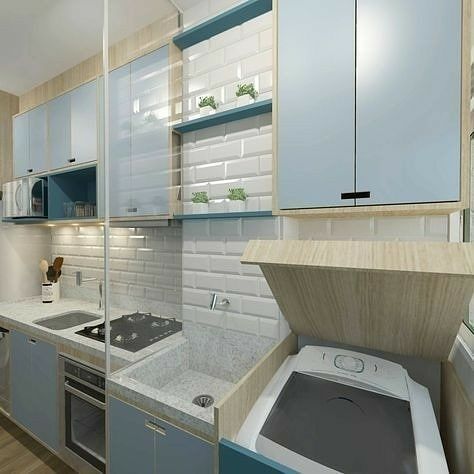 a kitchen with blue and white cabinets, a stove top oven and a washing machine