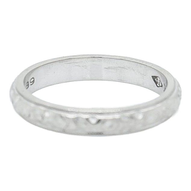 a white gold wedding ring with diamonds on the outside and in the inside, it is made out of silver