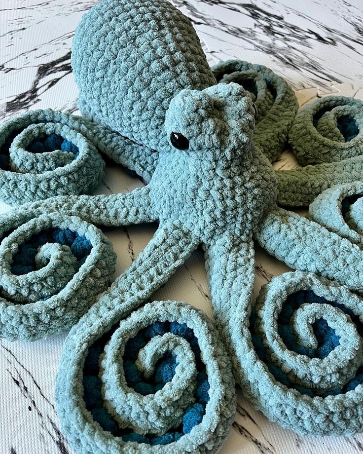 A crocheted octopus, sitting with its tentacles curled. The octopus is made with two tones of teal yarn. Crochet Kraken Pattern, Crochet Octopus Realistic, Free Octopus Pattern, Large Octopus Crochet Pattern Free, Free Crochet Octopus Pattern, Giant Octopus Crochet Pattern, Crochet Octopus Pattern, Octopus Crochet Pattern Free, Crochet Anchor