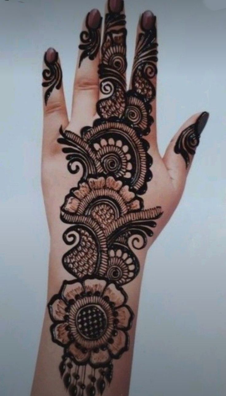 a woman's hand with henna on it