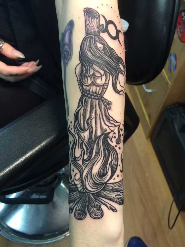 a woman's arm with an octopus tattoo on it