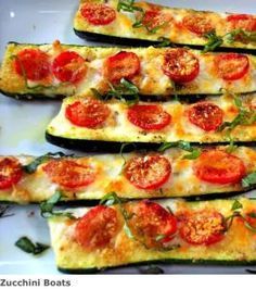 zucchini stuffed with tomatoes and basil on a white platter, ready to be eaten