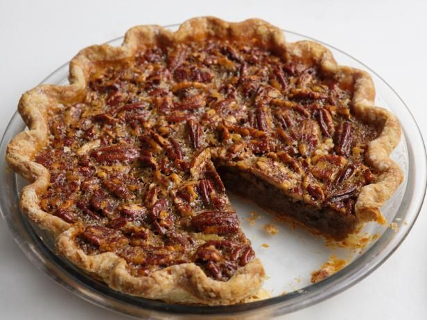 a pecan pie with one slice missing from it