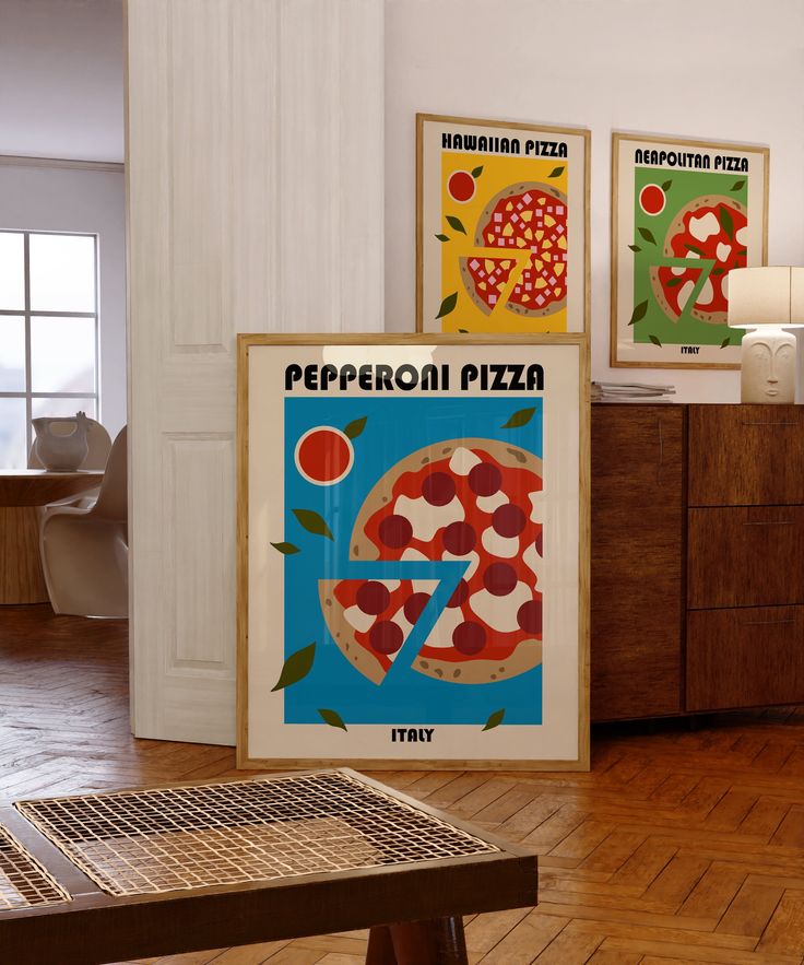 there are three posters on the wall in this living room, one is for pepperoni pizza