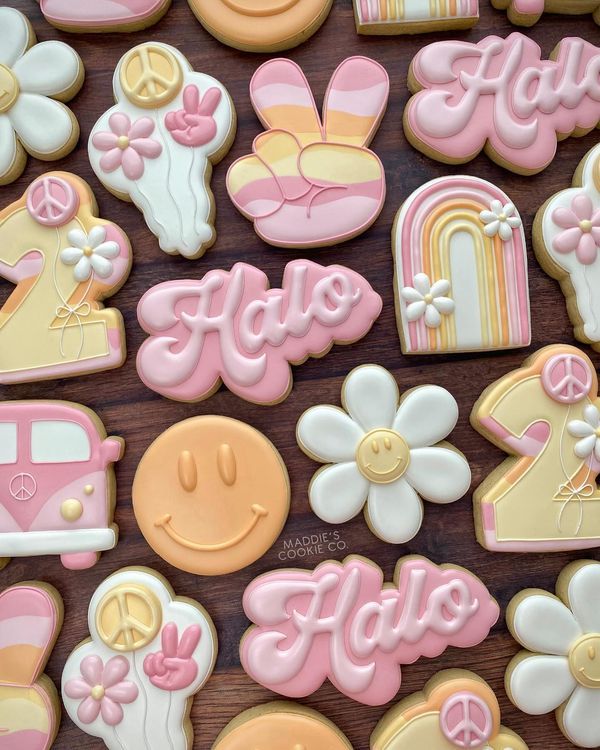 decorated cookies with the word hello written in large letters and flowers on them are arranged next to each other