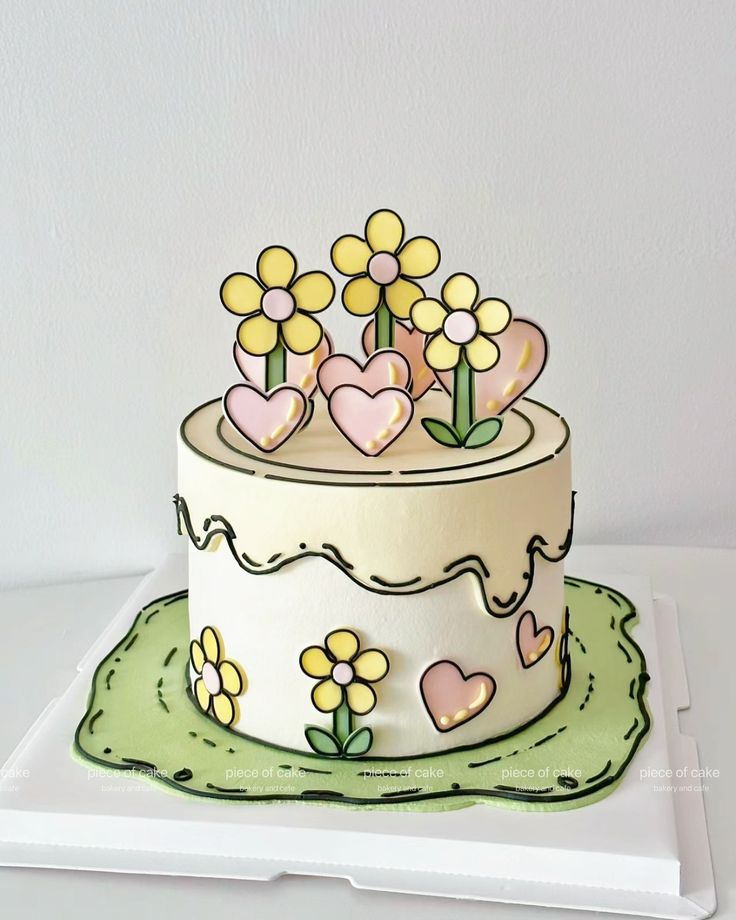 a white cake with yellow flowers and hearts on it