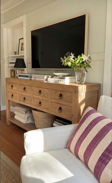 a living room with a large television mounted on the wall