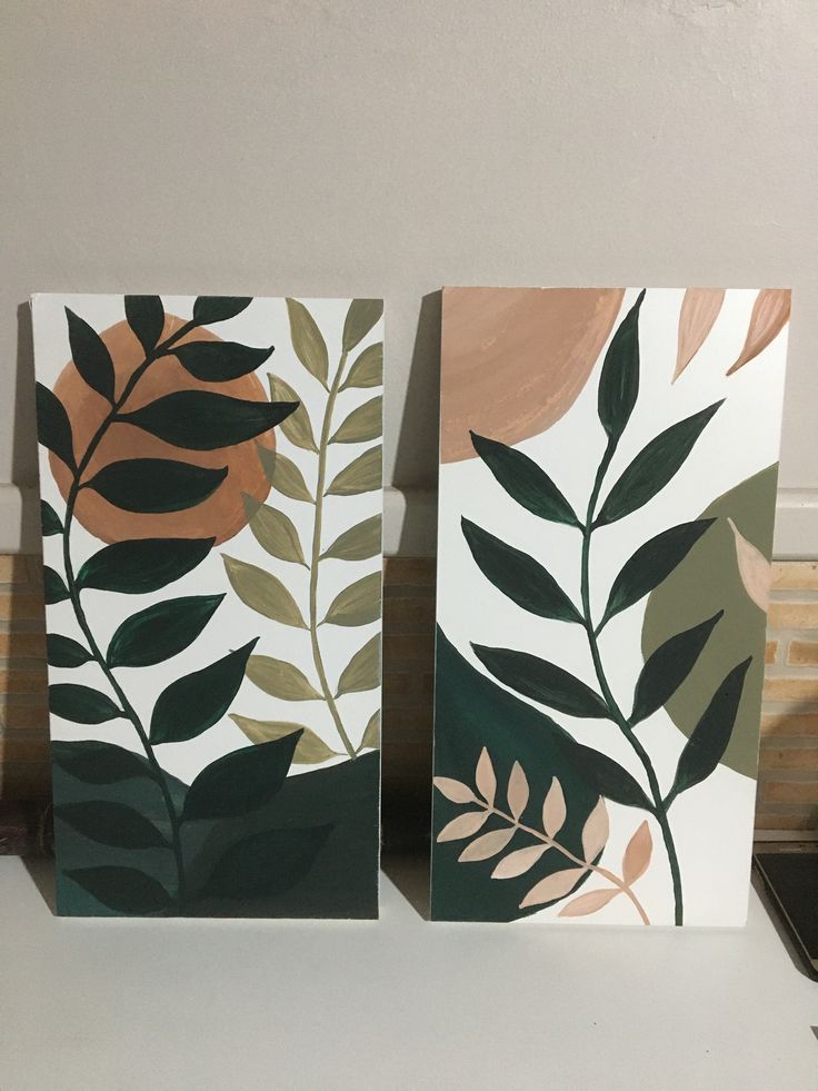 two paintings with leaves painted on them