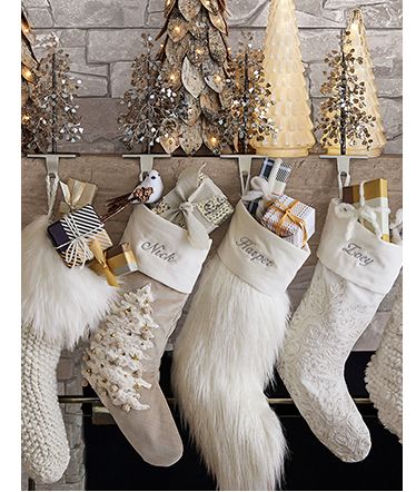 christmas stockings hanging from a fireplace with presents