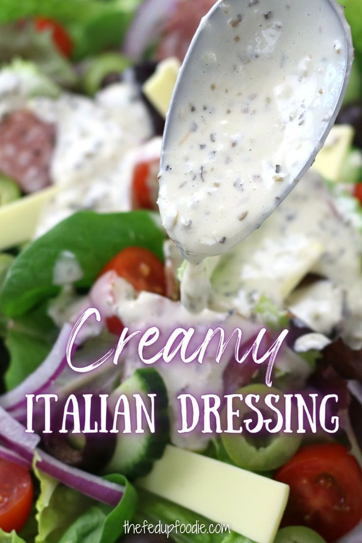 a salad with dressing being drizzled over it and the words creamy italian dressing