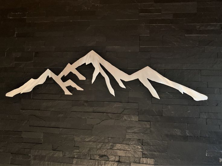 there is a paper cut out of mountains on the wall