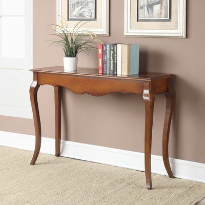 a wooden table with books and a potted plant sitting on it's side