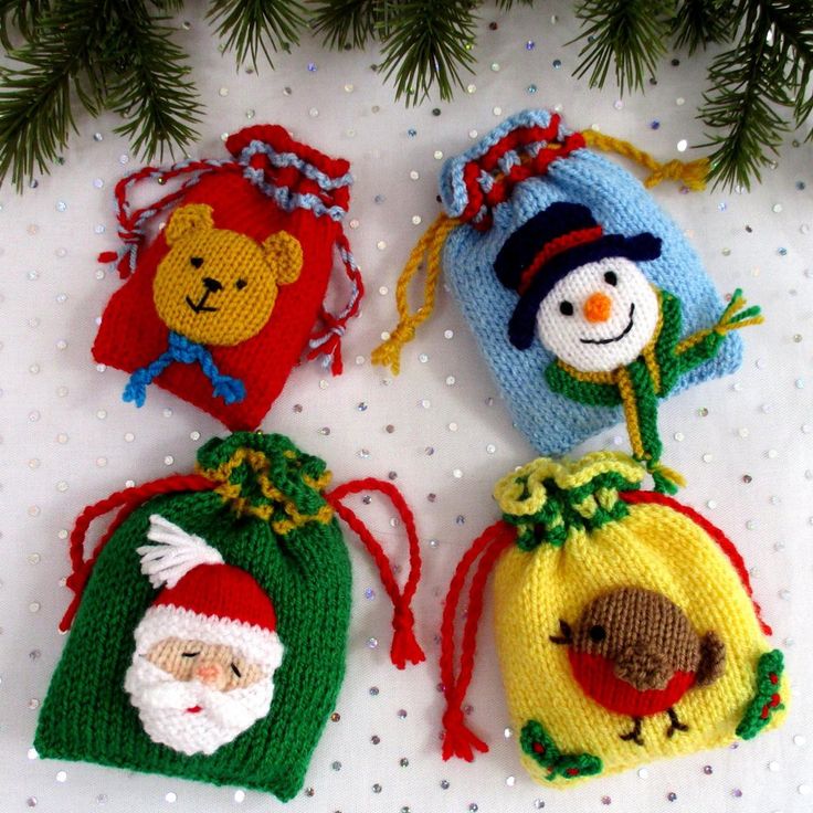 three knitted christmas ornaments hanging from a tree