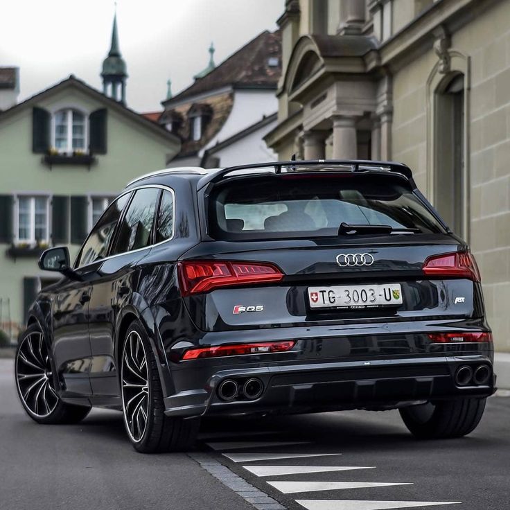 an audi car is parked on the street