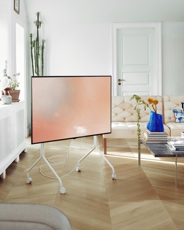 a flat screen tv sitting on top of a wooden floor