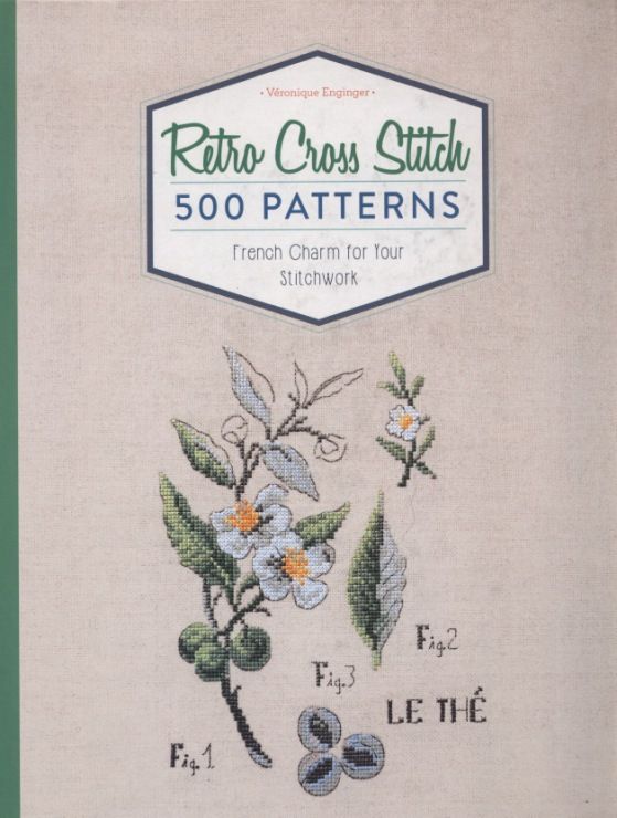 a cross stitch book with flowers on it