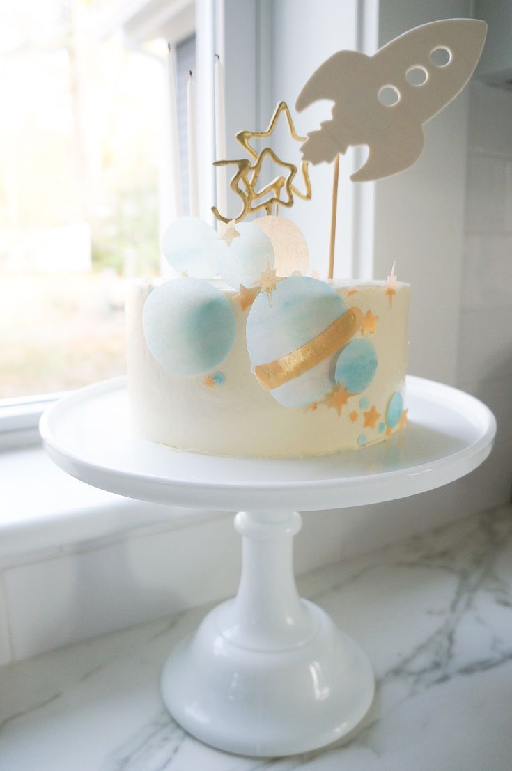 a white cake with blue and gold decorations