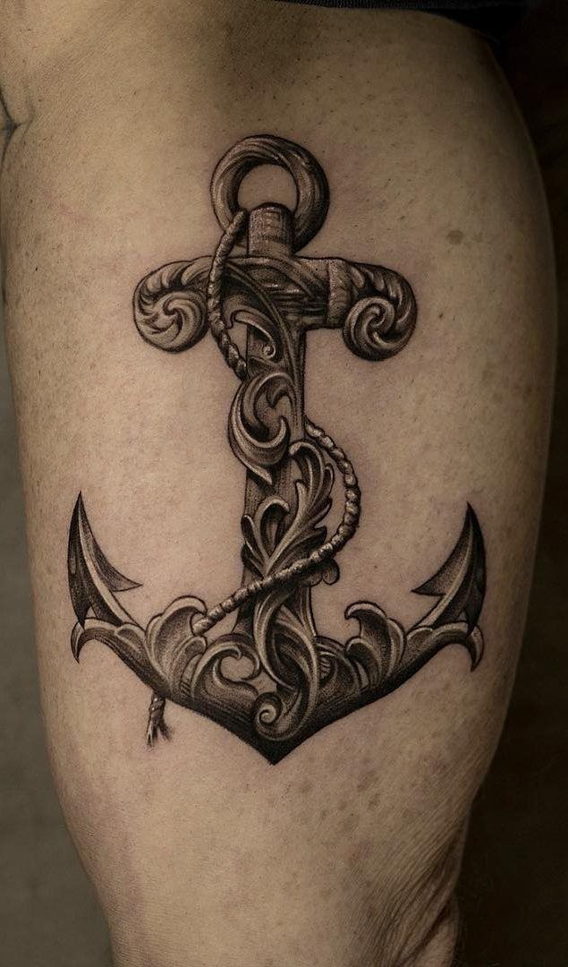 an anchor tattoo is shown on the thigh and it's intricately detailed design