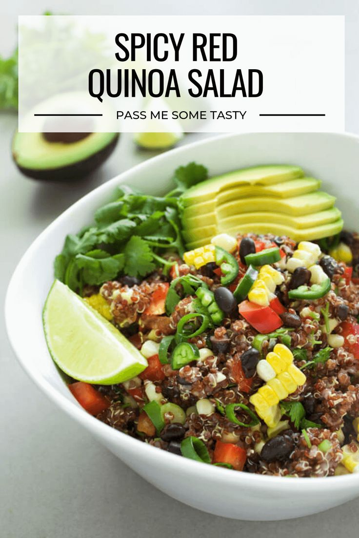 a white bowl filled with quinoa salad next to sliced avocado