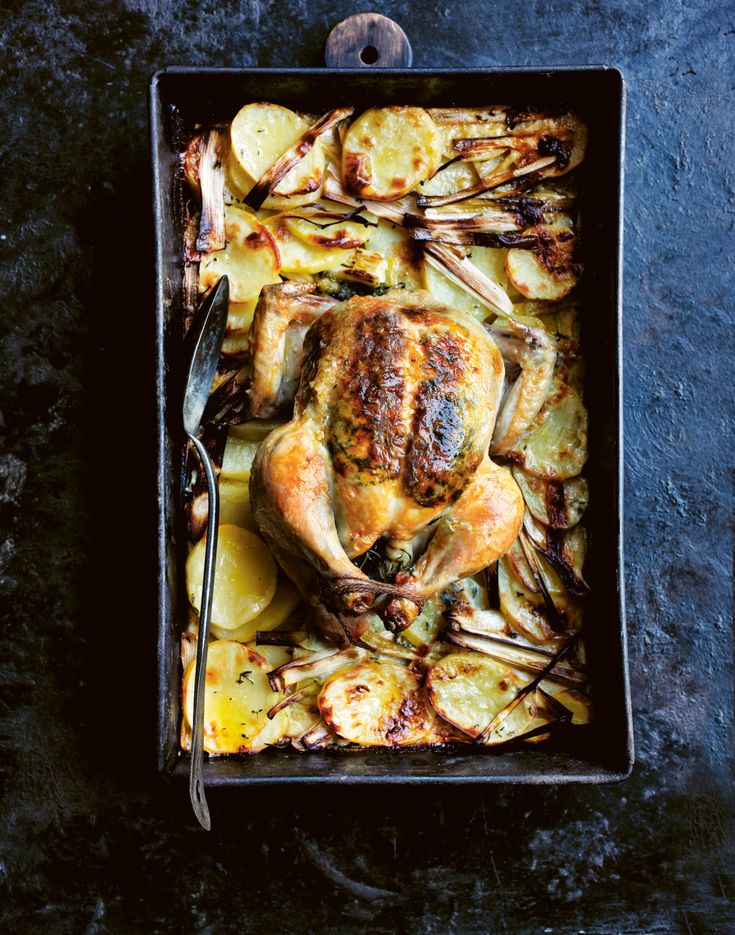 a roasting pan filled with chicken and potatoes