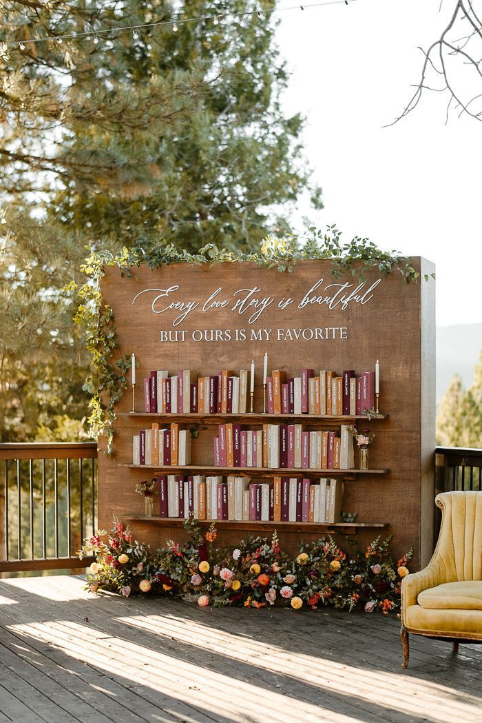 a chair and book shelf with books on it in front of a sign that says, every day is beautiful but ours is my favorite